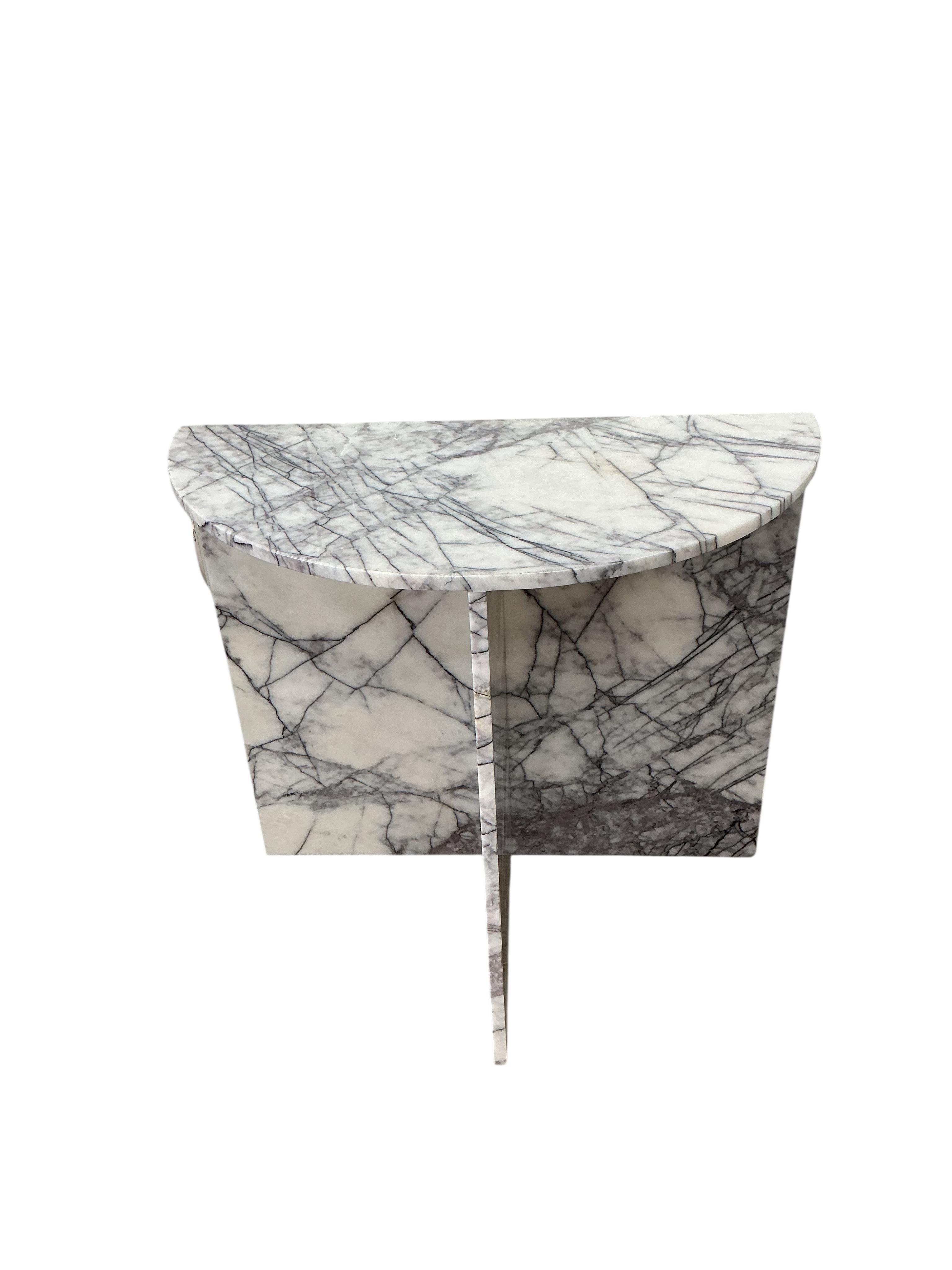 A near pair of reconstituted marble demi lune console tables, width 80cm, depth 42cm, height 75cm